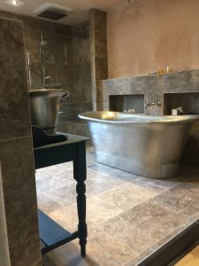 Granite tiles and shower tray laid over a Lewis Deck and Concrete floor upstairs over timber joists