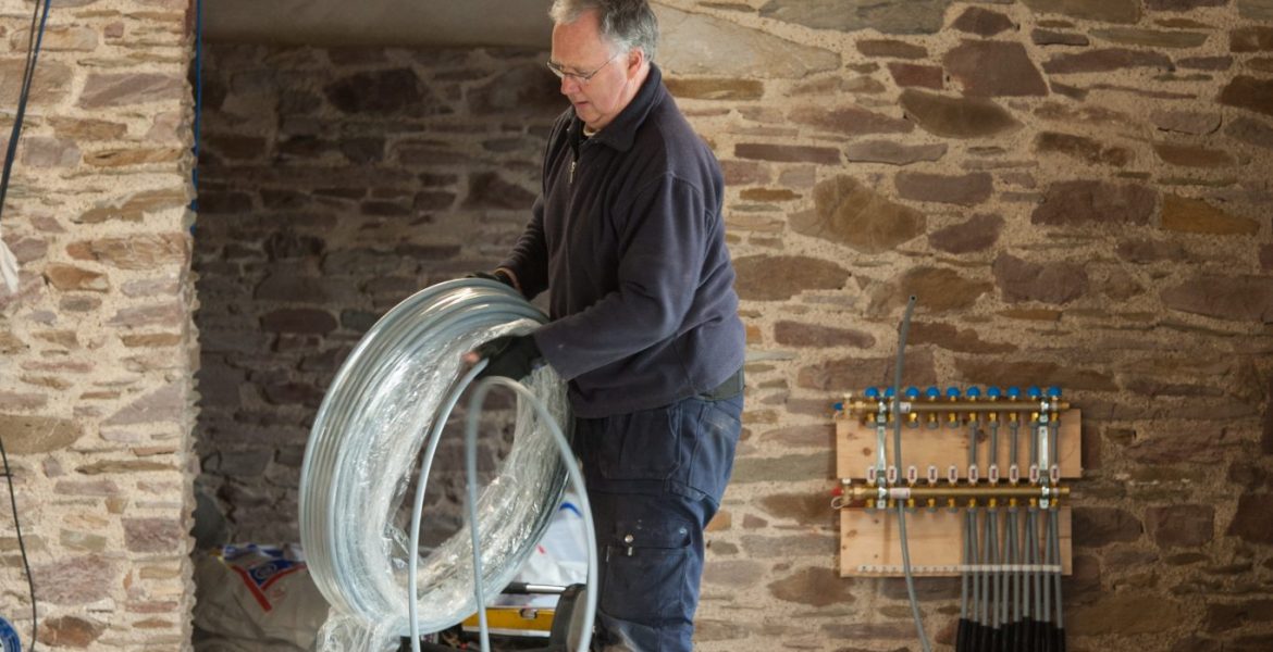 underfloor heating pipe being laid on Lewis Plate