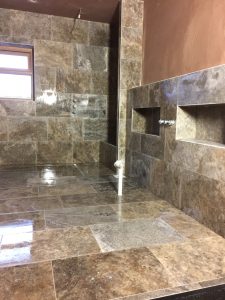 Travertine tiles within a Lewis Deck wet-room with concrete