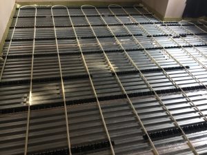 Lewis Deck with underfloor heating pipes in clip rails